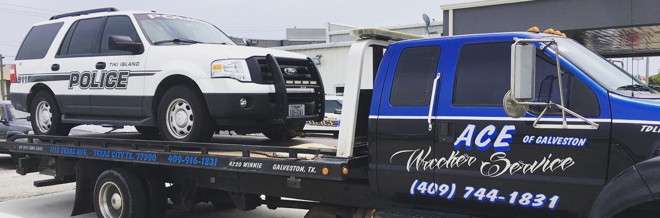 Ace of Galveston truck towing a police SUV